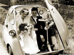 married couple in a tiny car